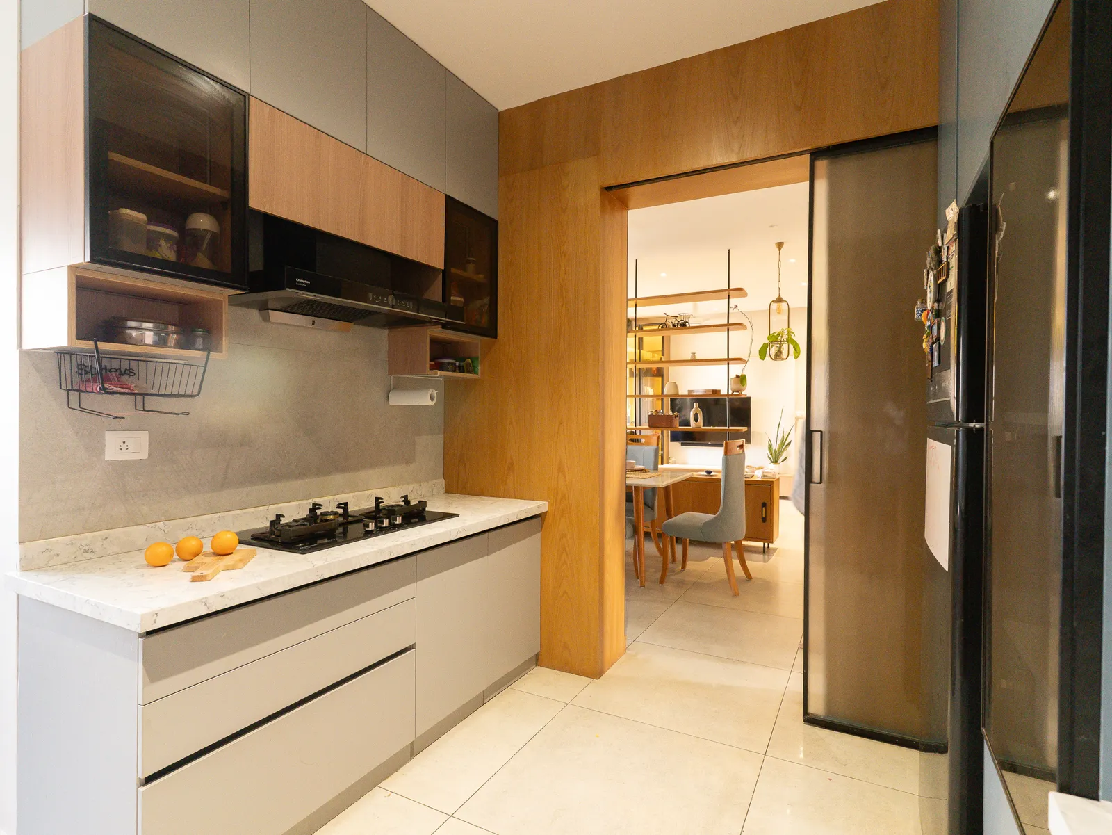Kitchen with hob and view through to the dining area — Amlan's Residence